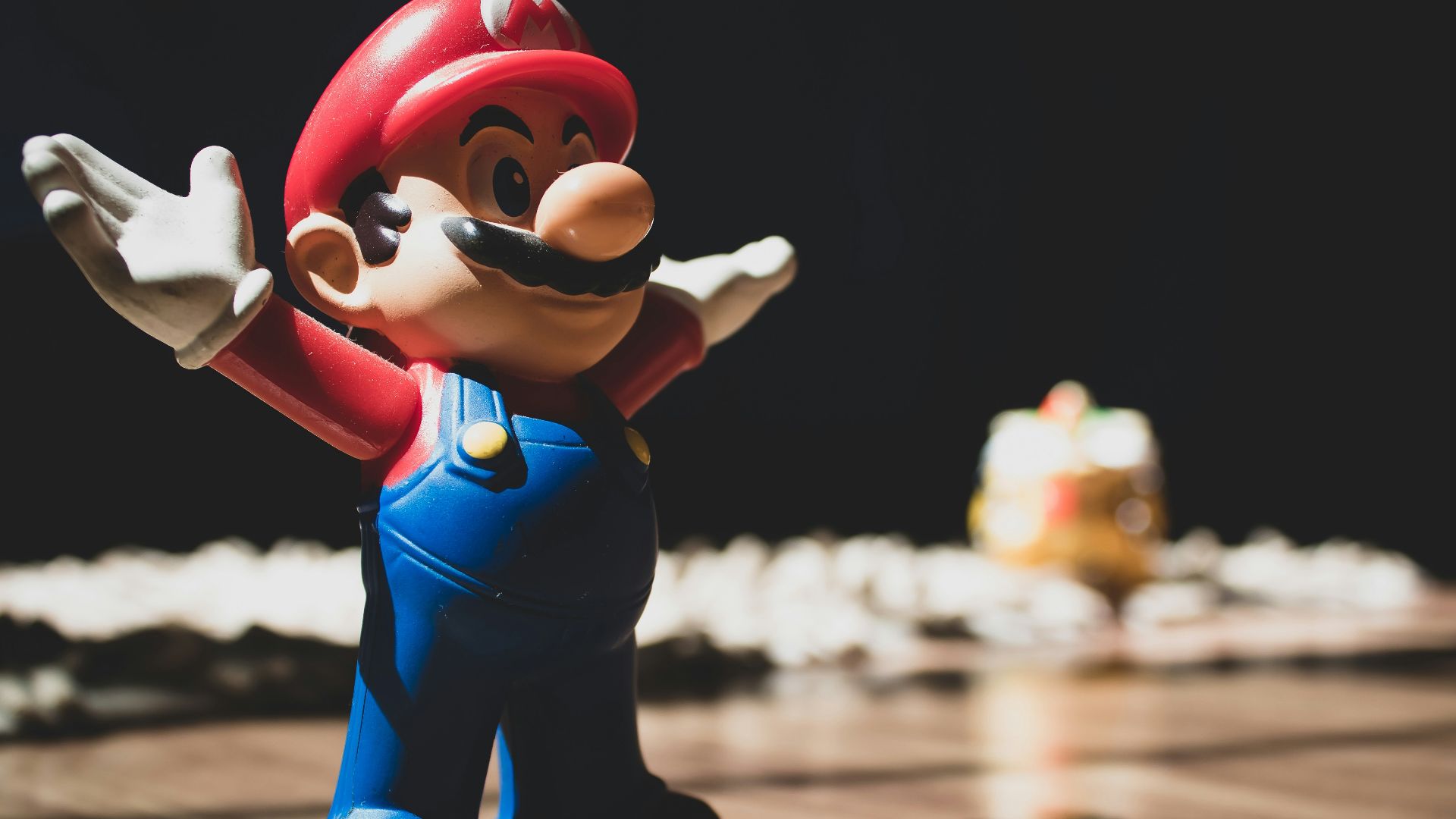 Super Mario figurine on brown surface