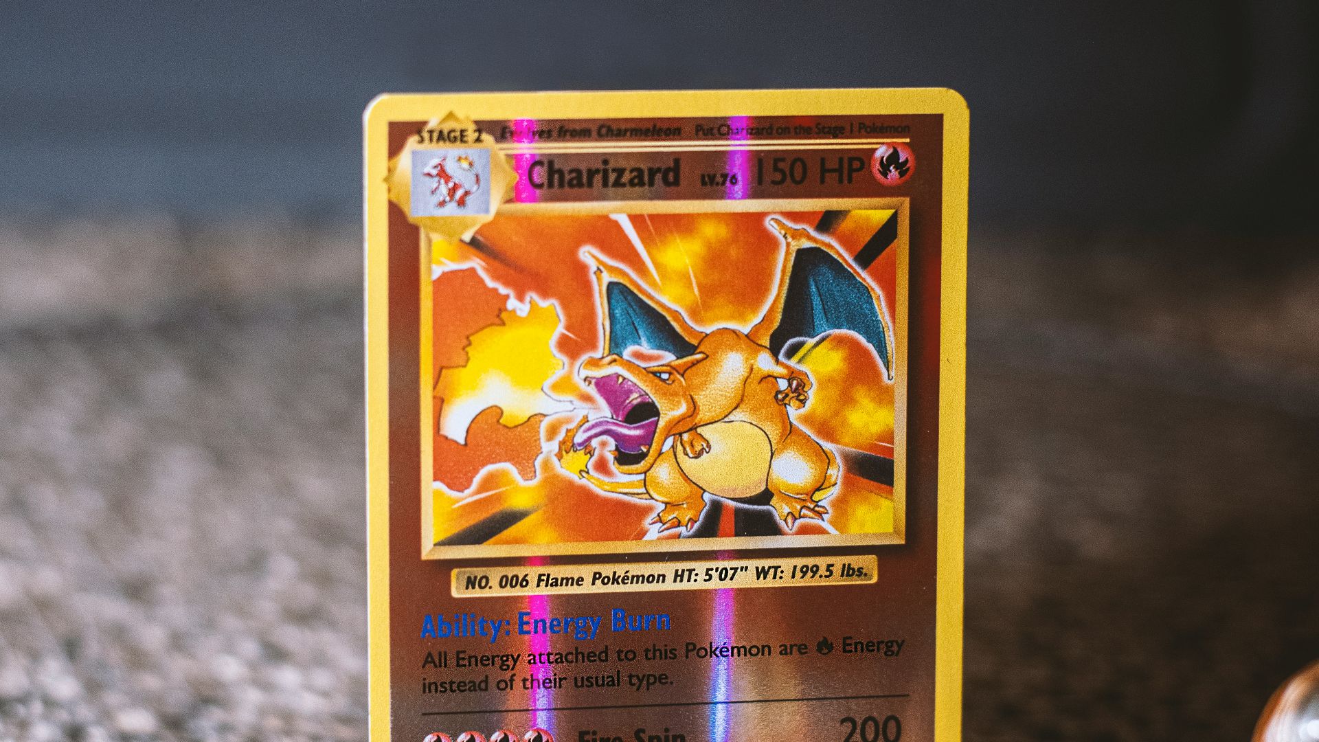 pokemon trading card on gray textile