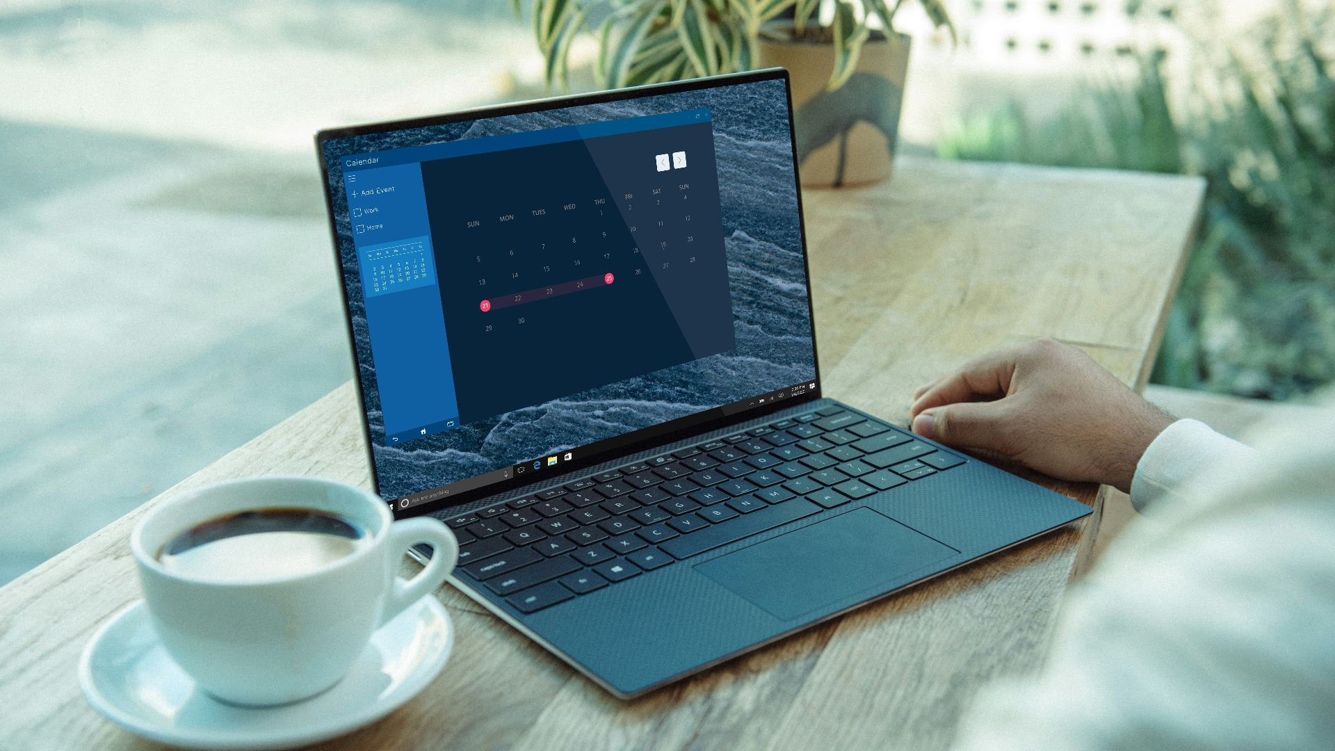 person using black laptop computer on brown wooden table