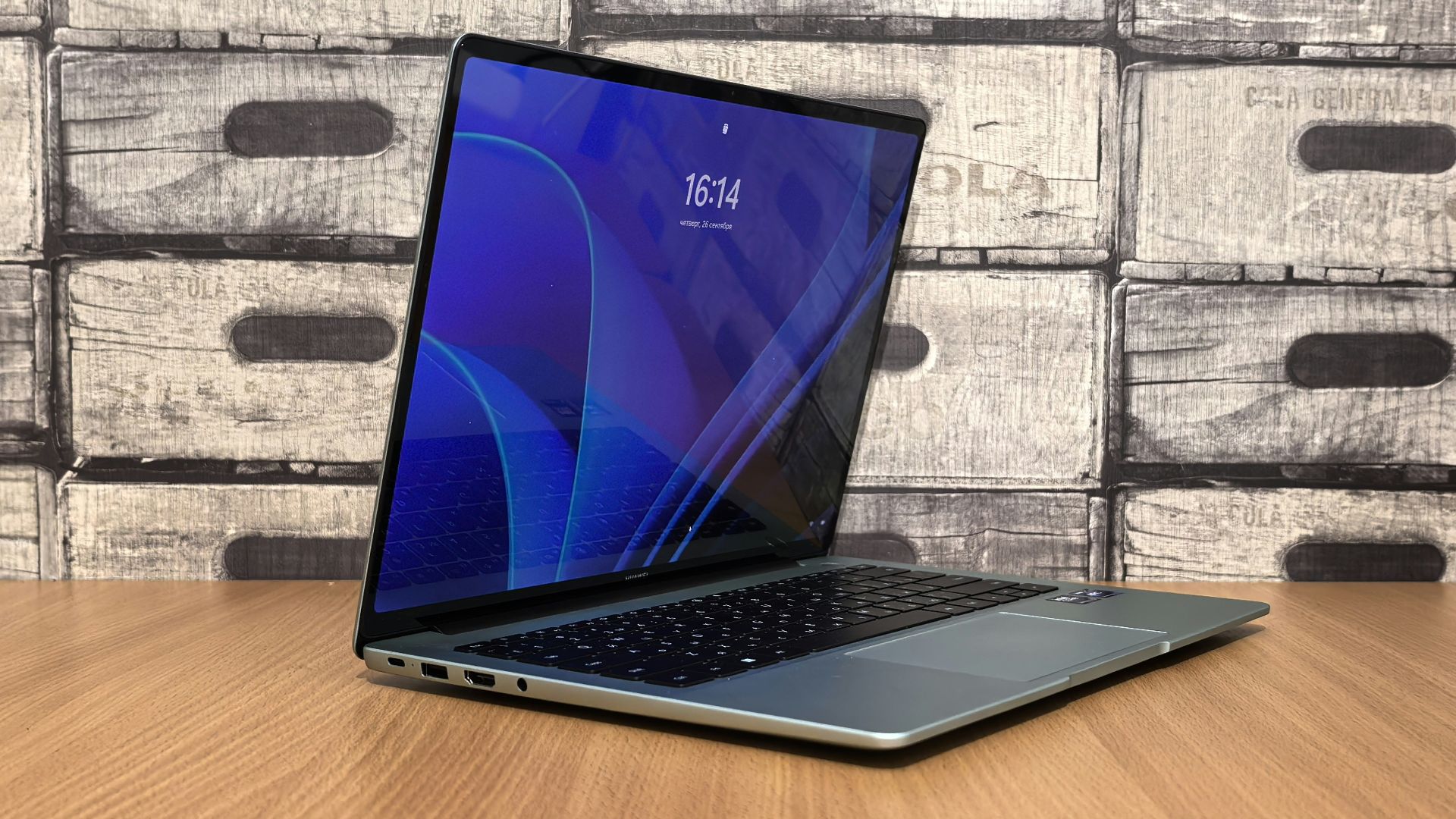 A laptop computer sitting on top of a wooden table