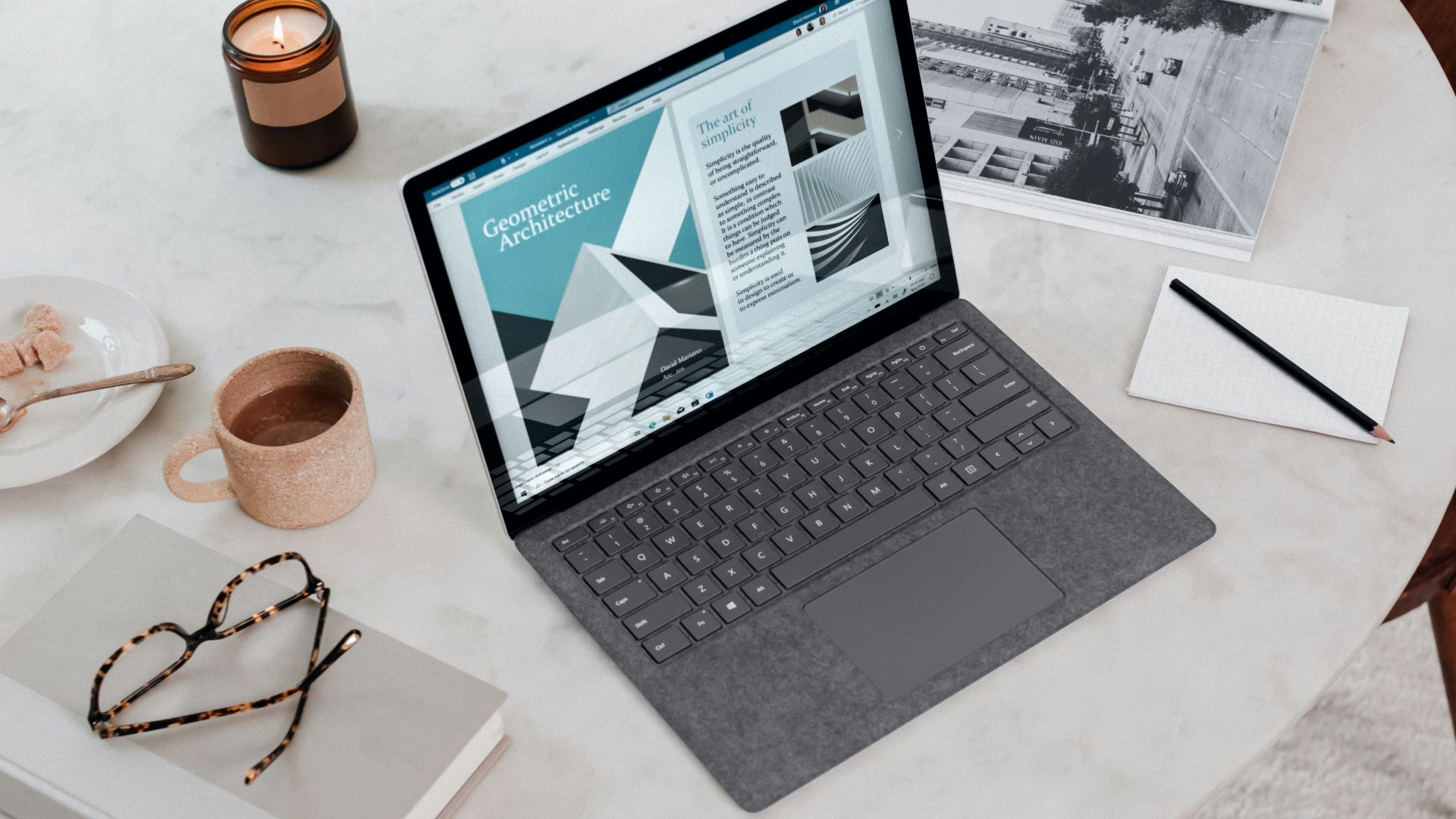 black laptop computer on round table on a Surface Laptop