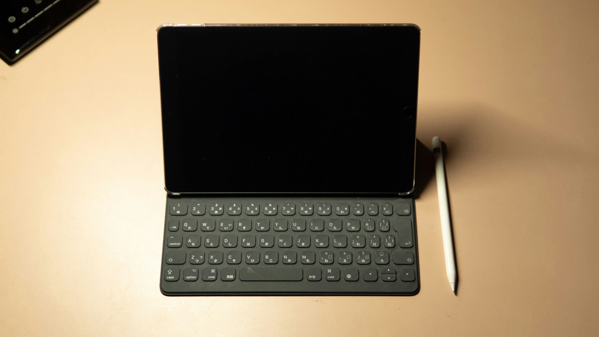 black tablet computer keyboard on white table
