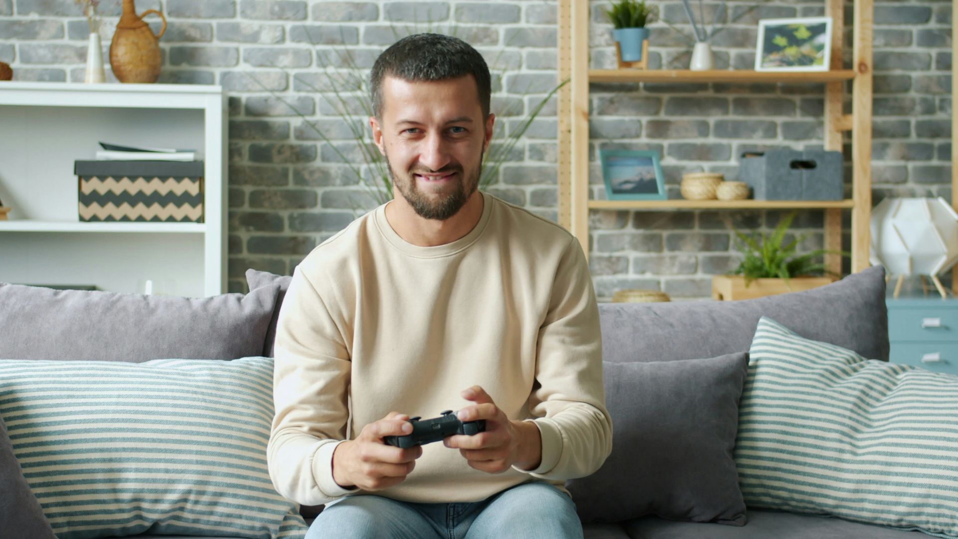 Man playing video games on a couch