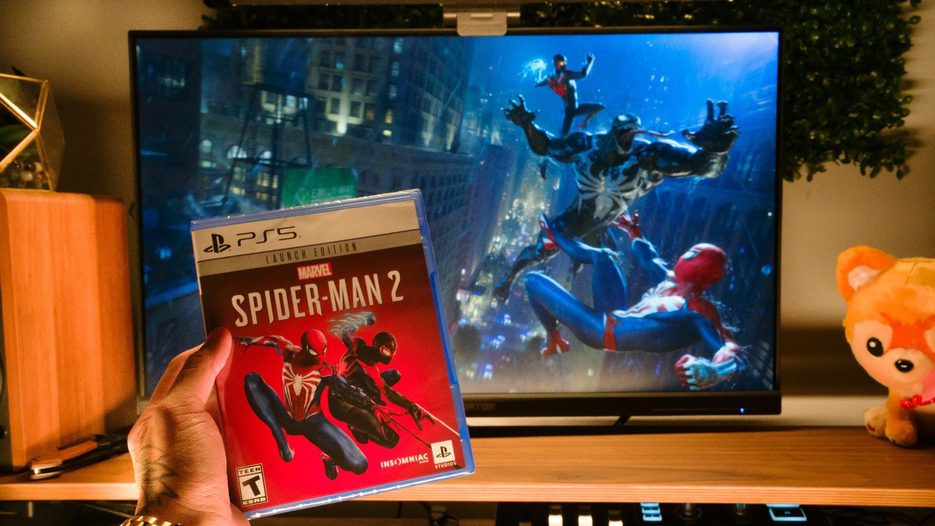 a person holding a video game in front of a television