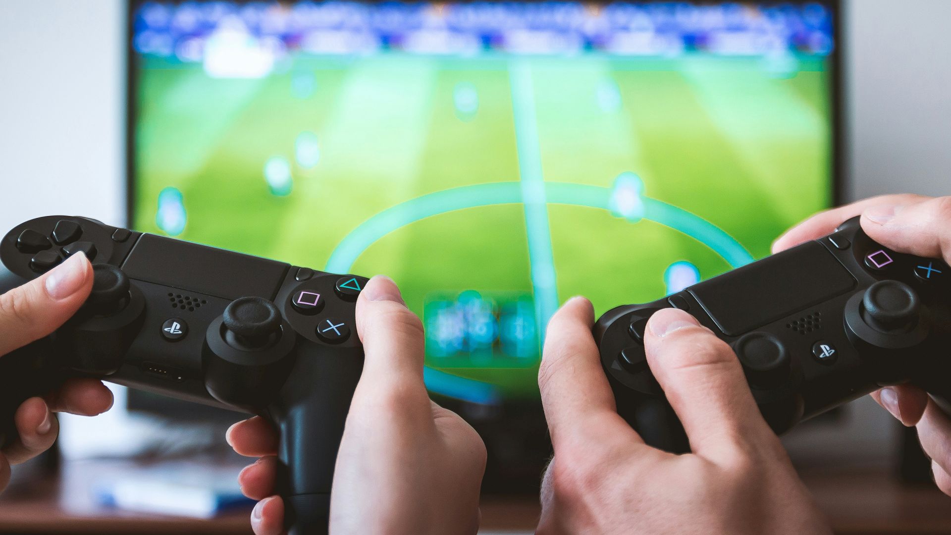 two people playing Sony PS4 game console