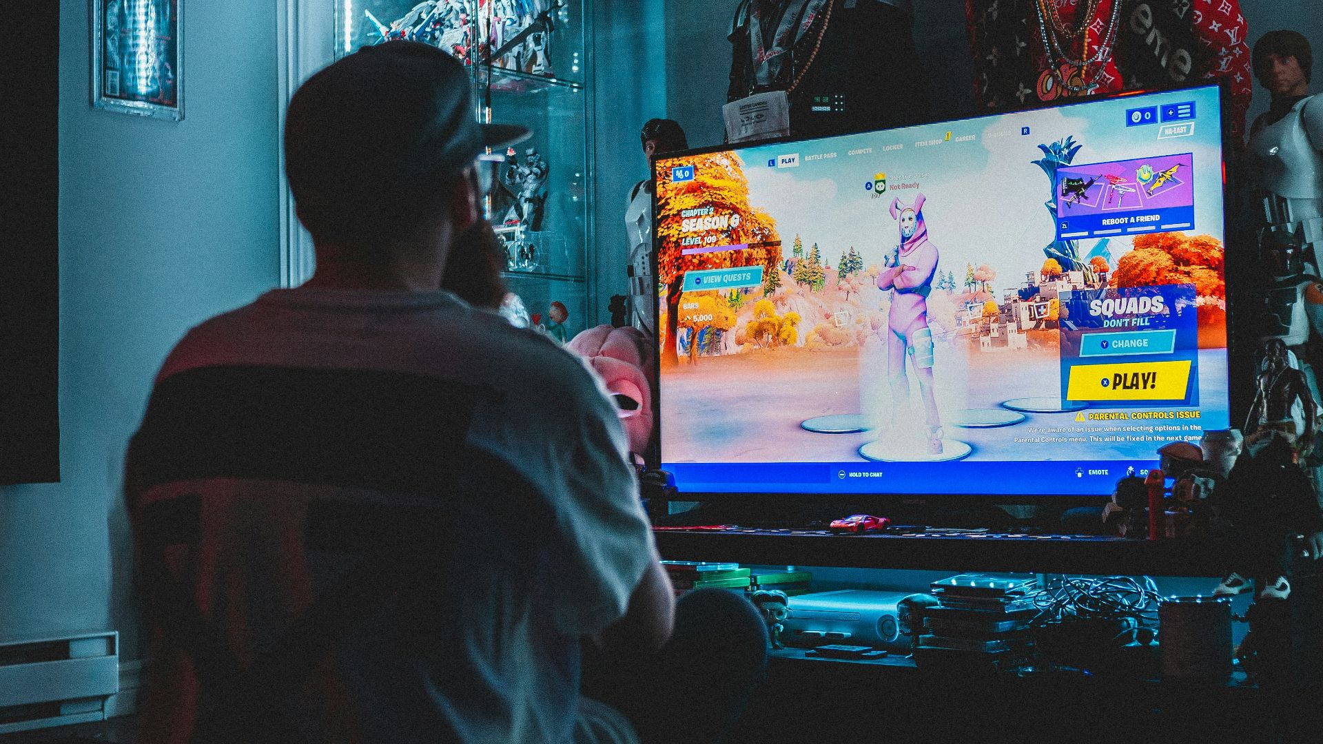 man in red shirt watching tv
