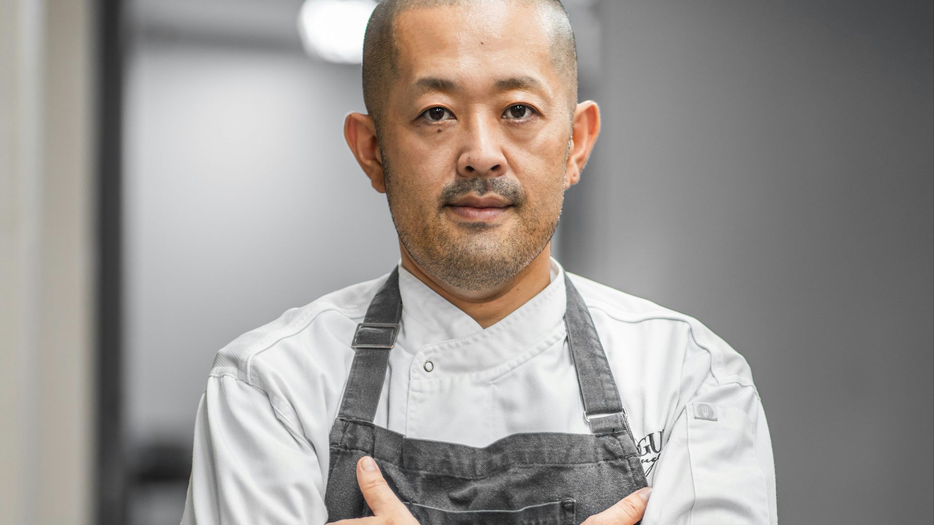 man in white button up shirt and black vest