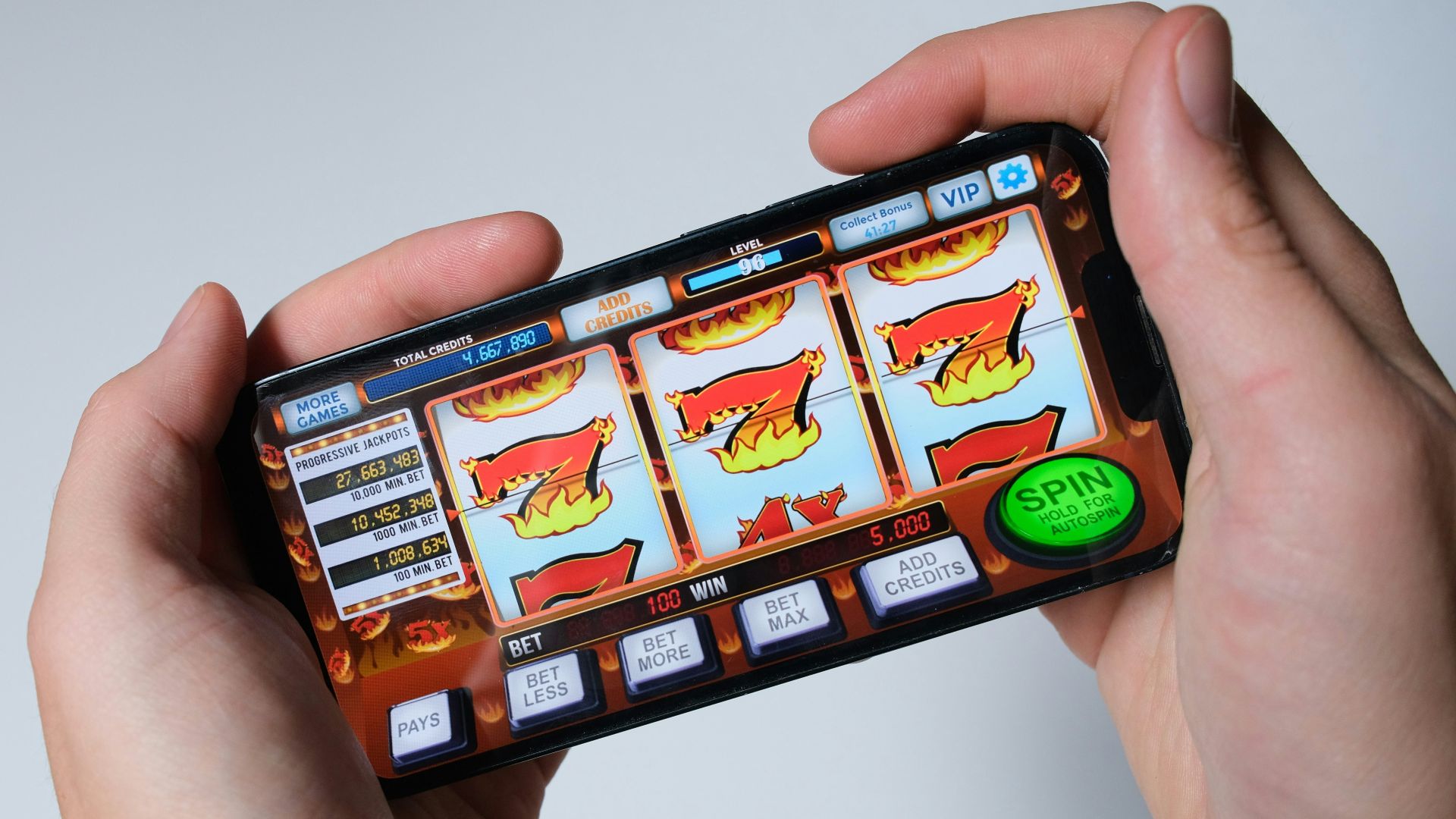 Someone is playing a mobile slot machine game.