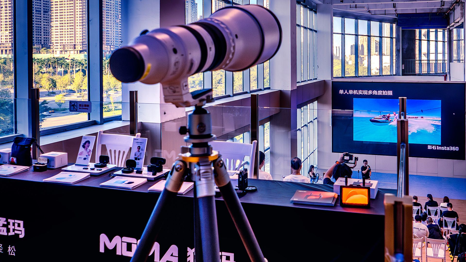 Telephoto lens on tripod at exhibition