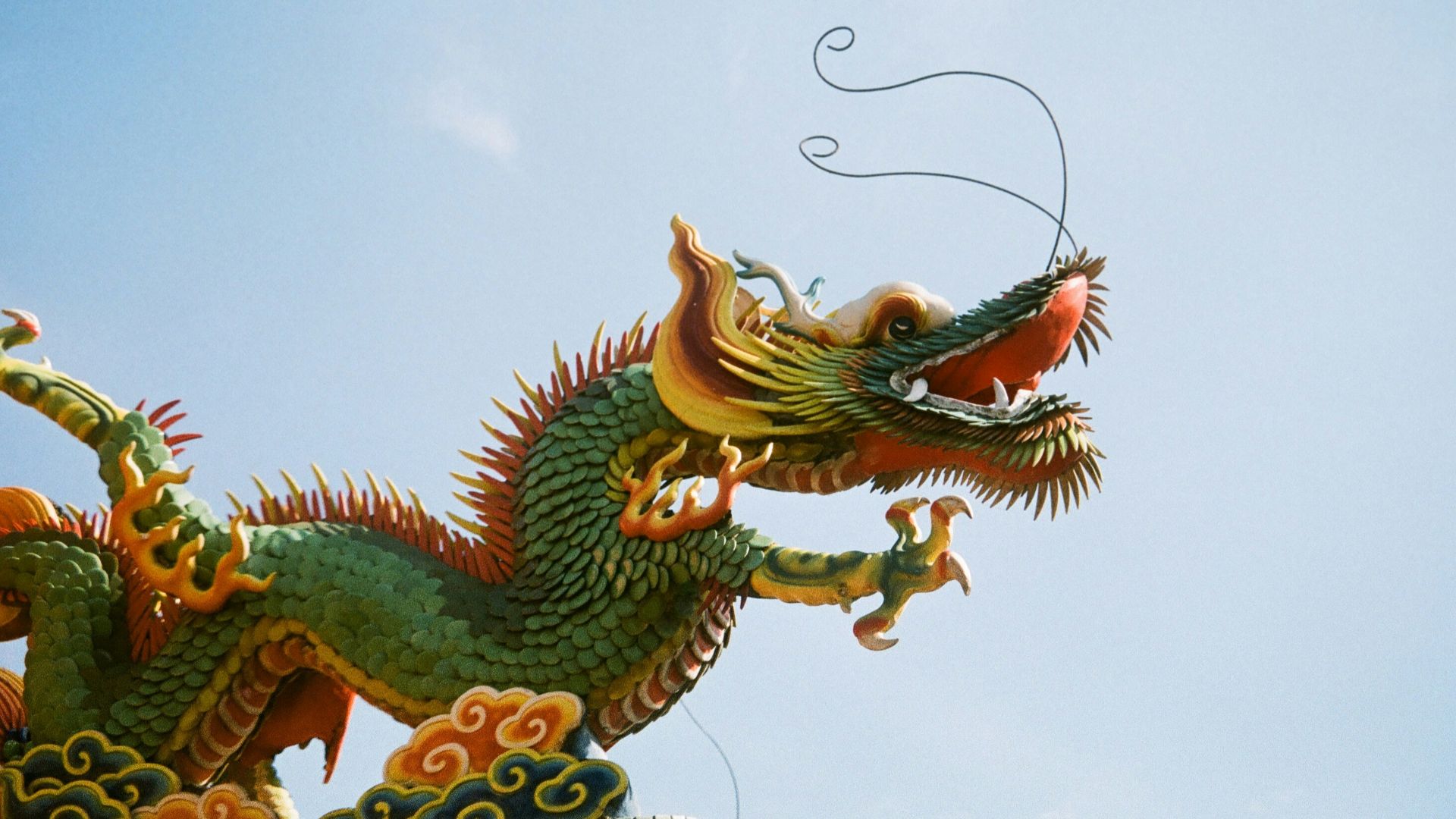 a dragon statue on top of a building