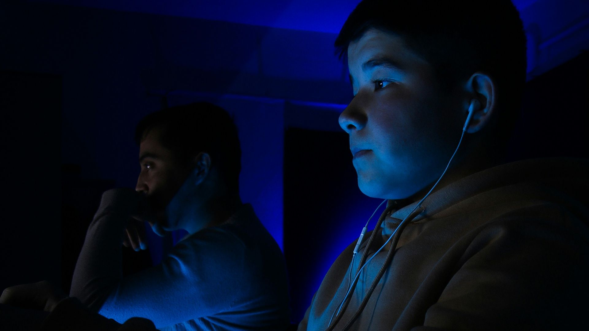 a man sitting at a table in a dark room