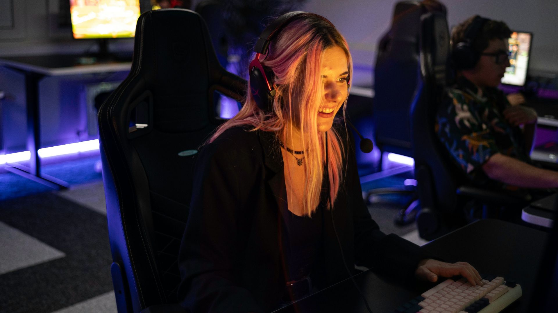 A woman sitting in front of a computer monitor
