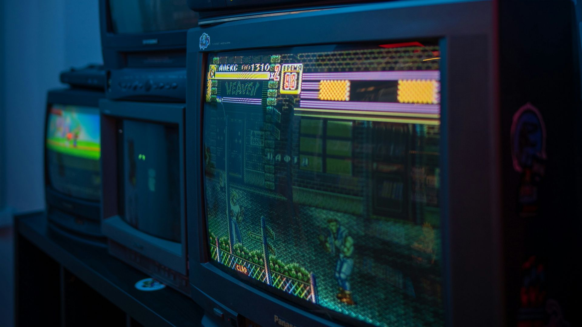 black crt tv turned on on brown wooden tv rack