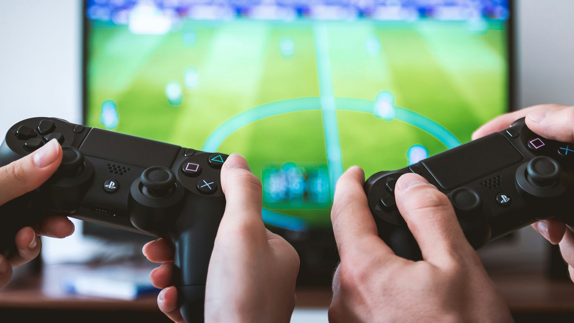 two people playing Sony PS4 game console