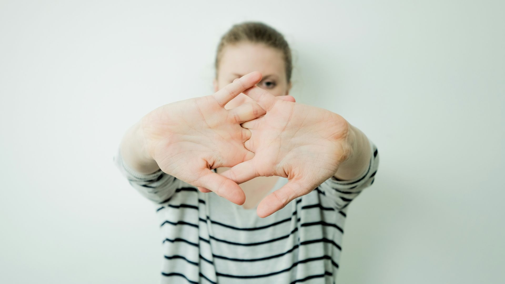 a woman making a heart with her hands