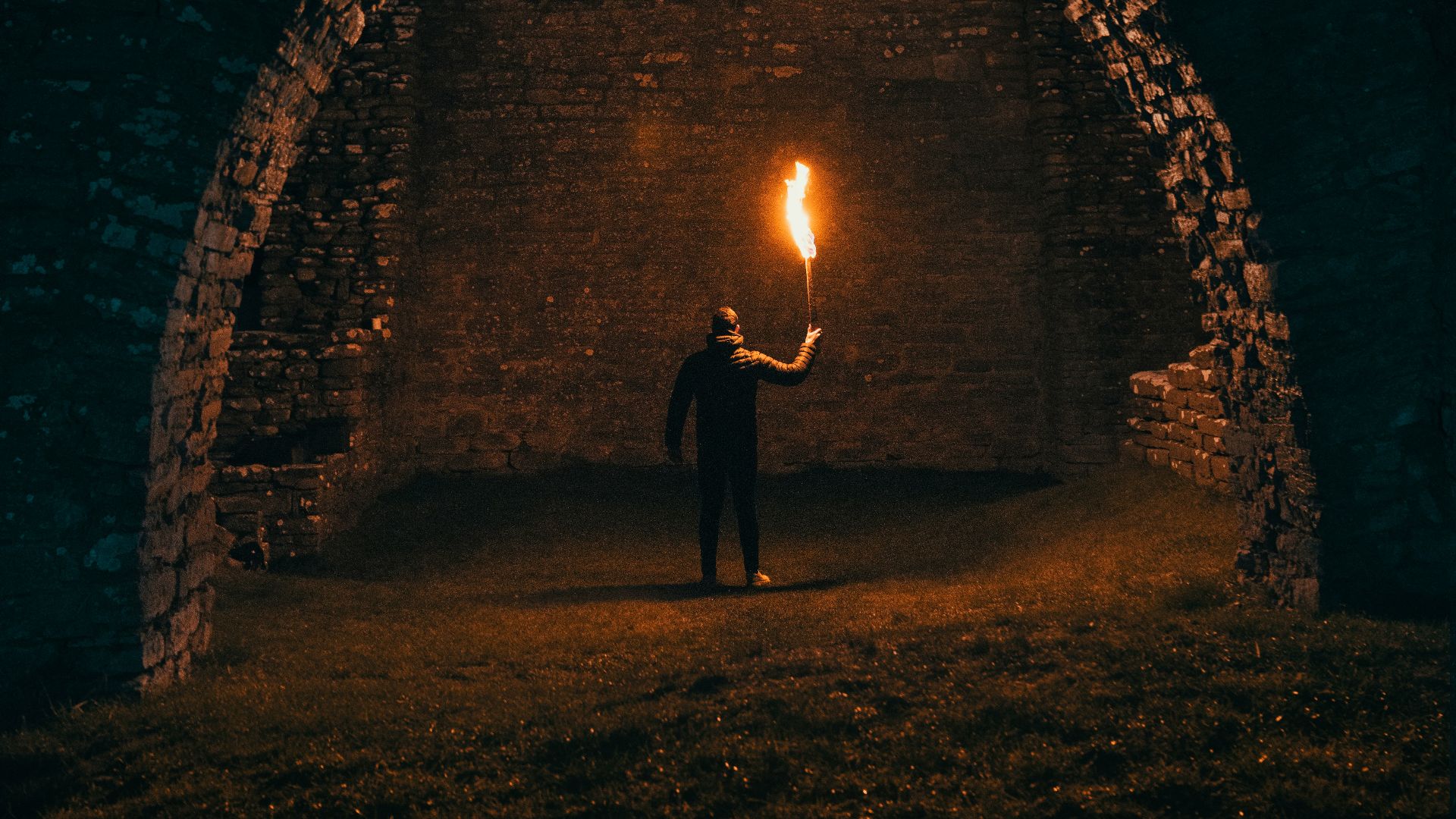 person holding torch in building interior