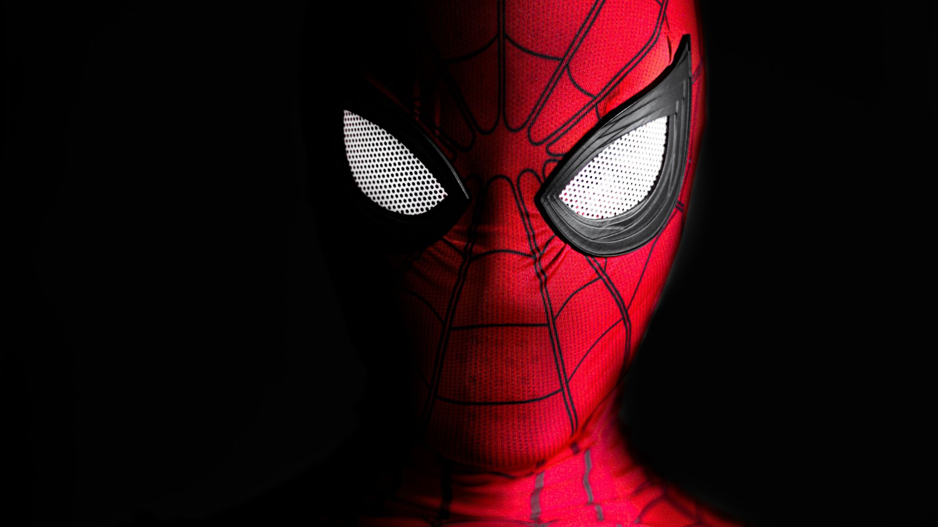 a close up of a spider man with glowing eyes