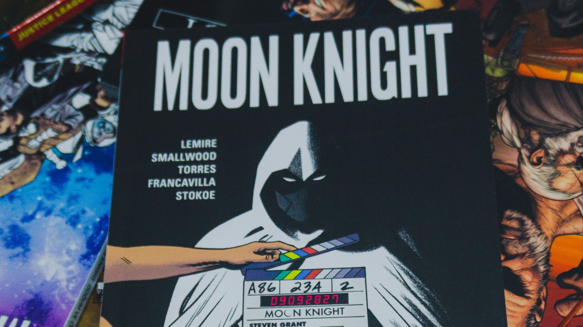 a pile of comic books sitting on top of a table