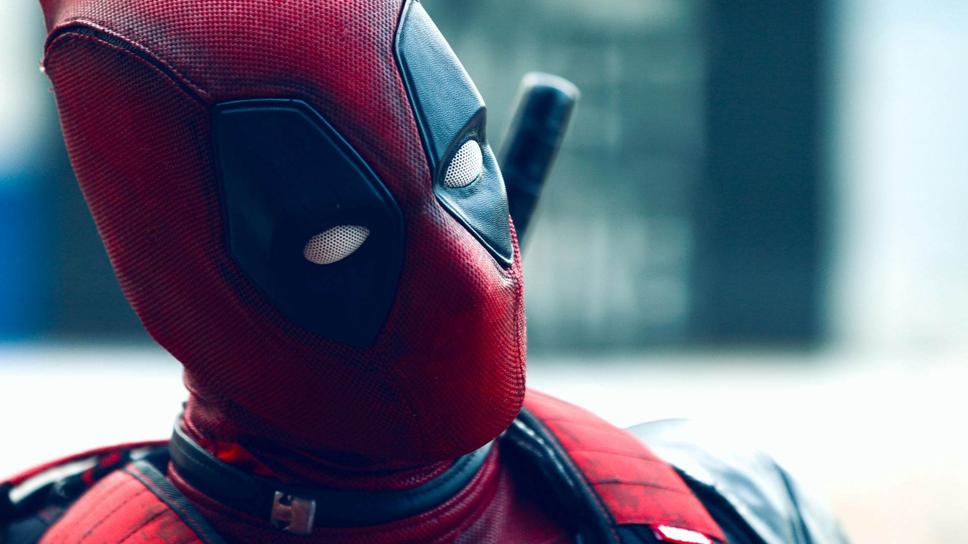 a man in a deadpool costume with a knife in his hand