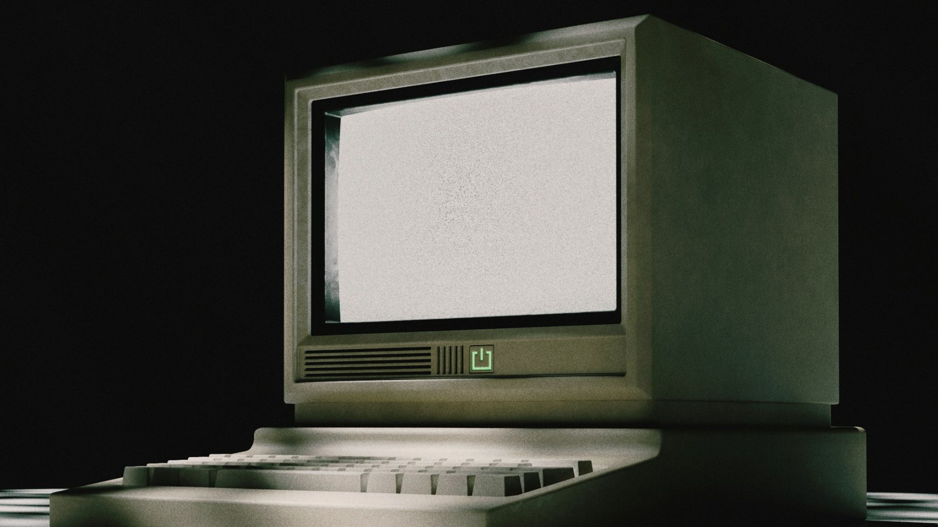 A vintage computer sits on a patterned surface.
