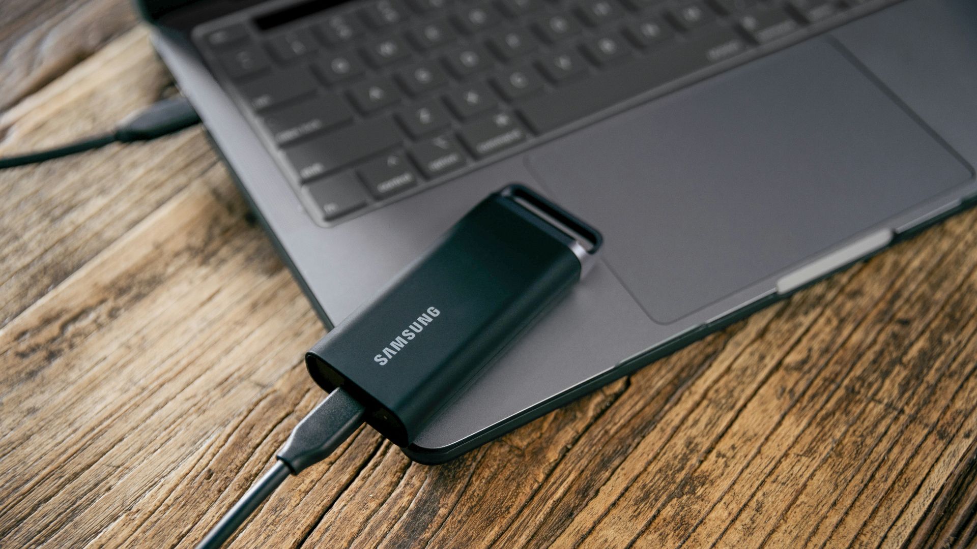A laptop computer sitting on top of a wooden table