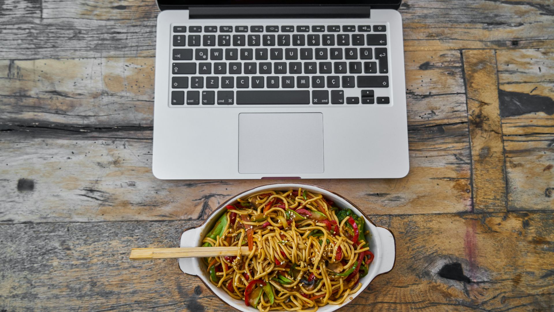 white macbook air on brown wooden table