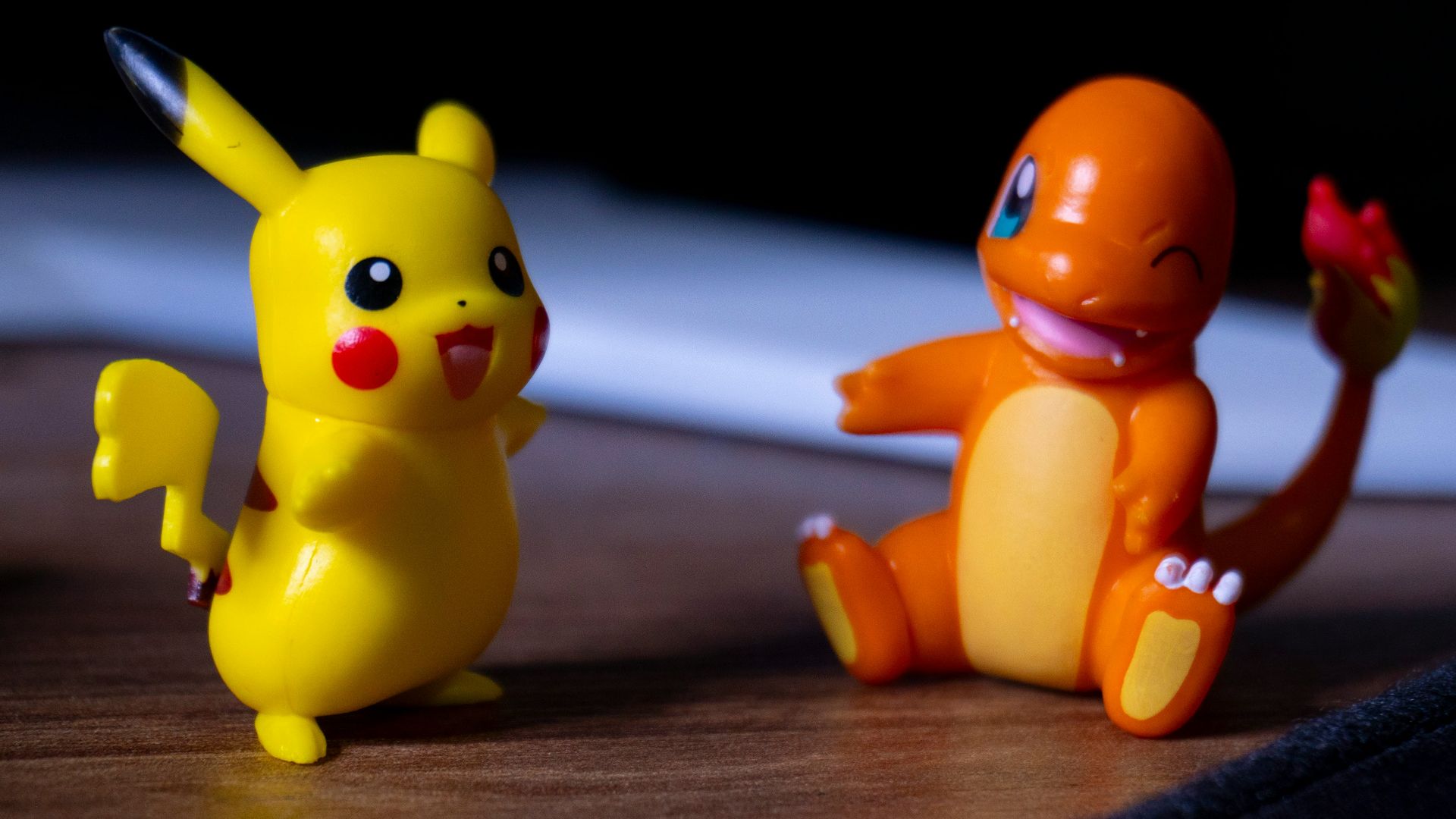 A couple of toy figurines sitting on top of a wooden table