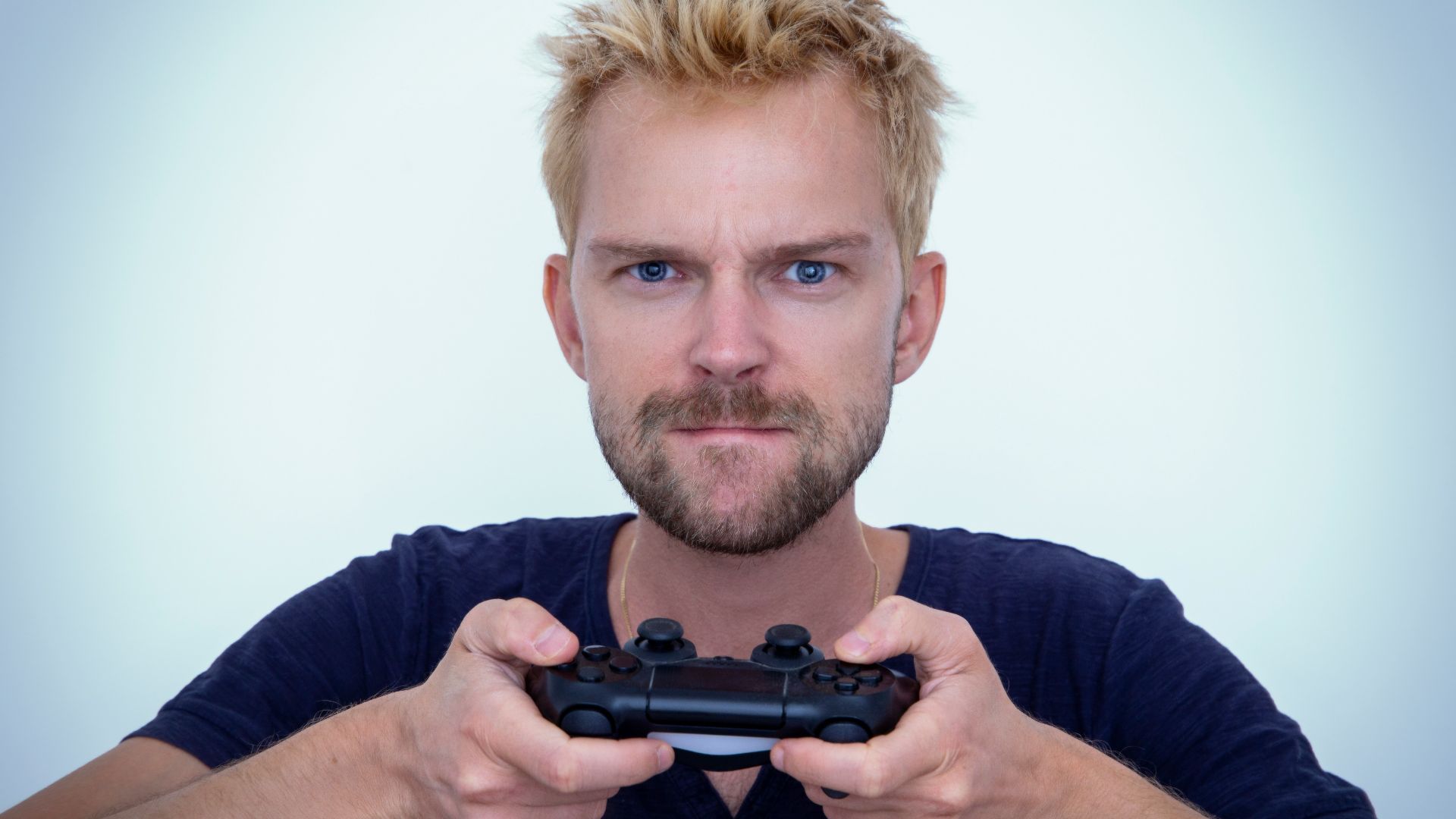 man in blue long sleeve shirt holding black semi automatic pistol