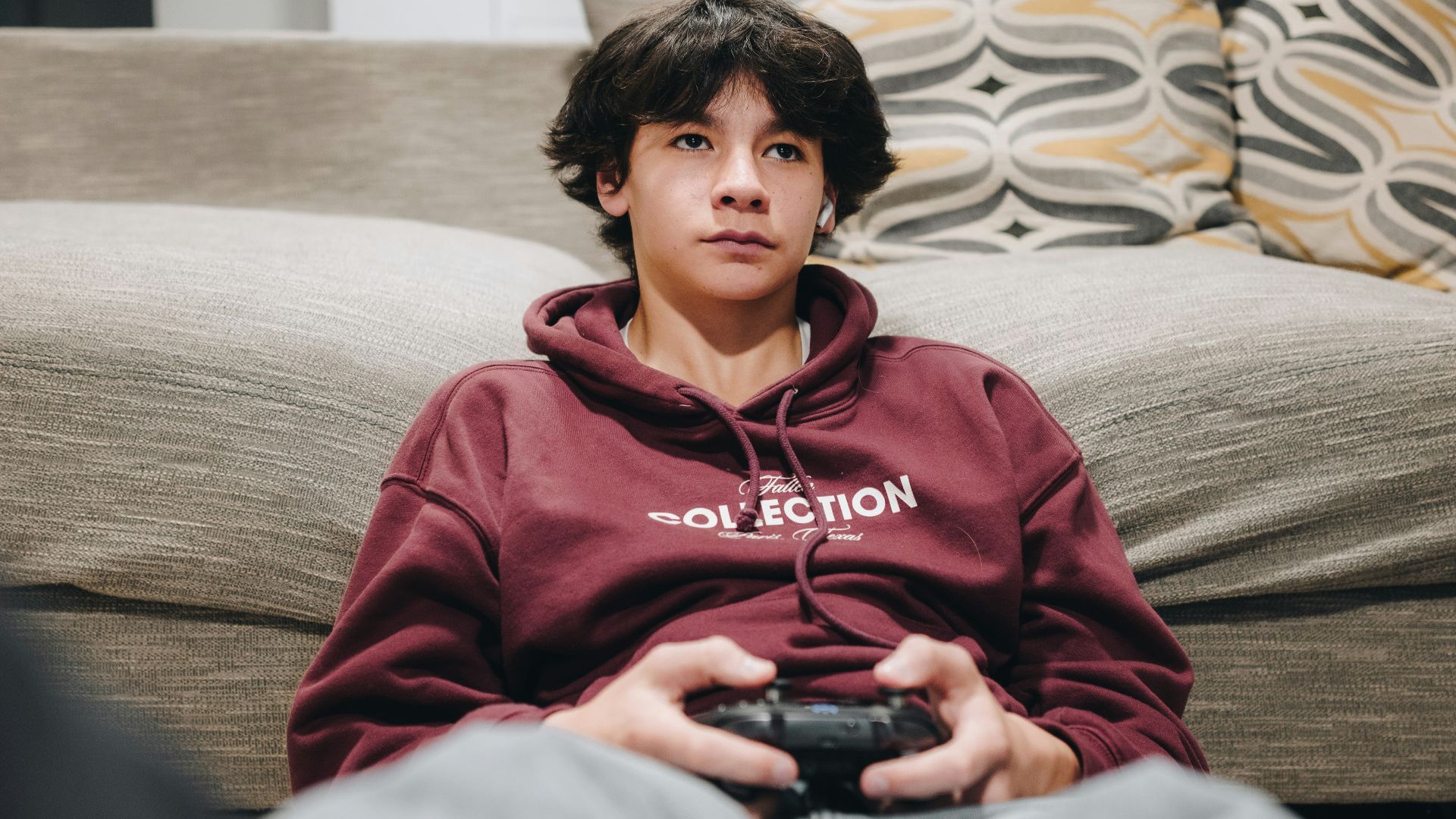 A young boy is playing a video game.