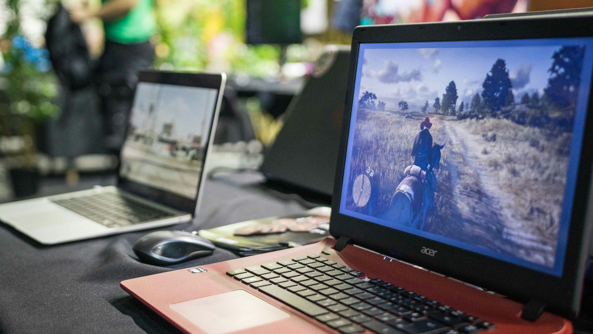 a couple of laptops sit on a table