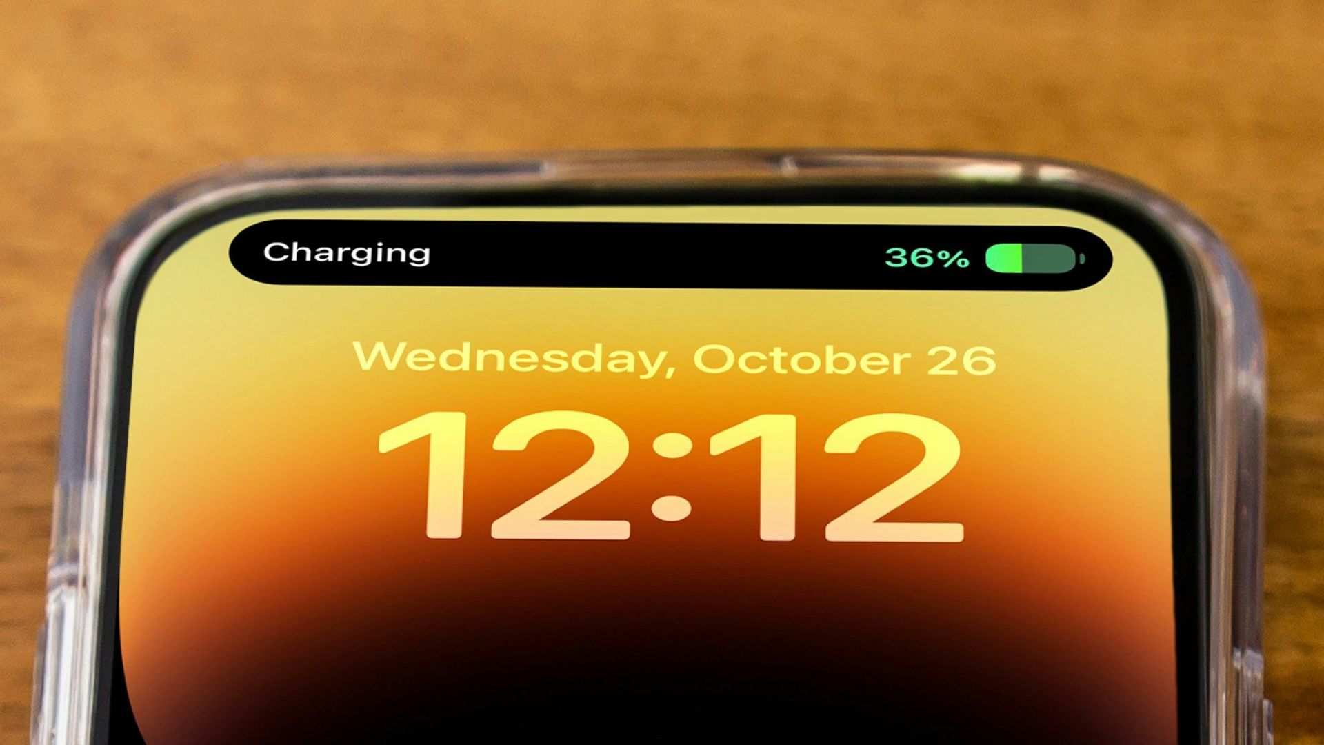 a cell phone sitting on top of a wooden table