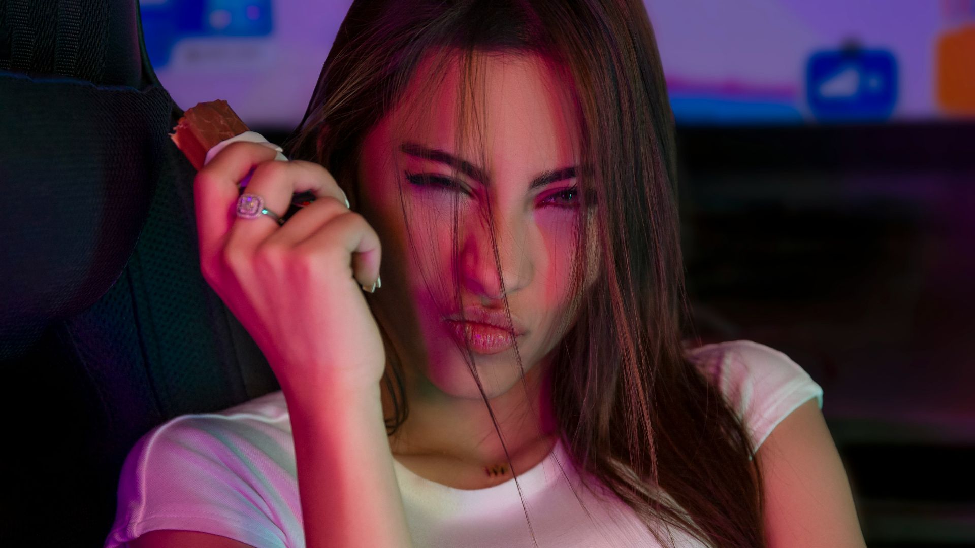 A woman sitting in a car talking on a cell phone