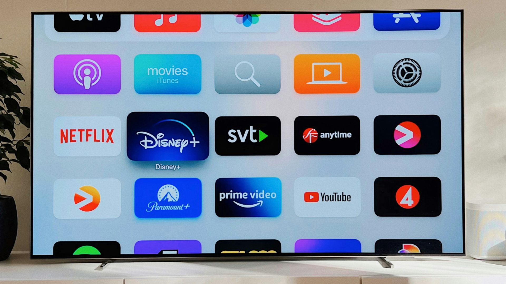 a flat screen tv sitting on top of a white cabinet