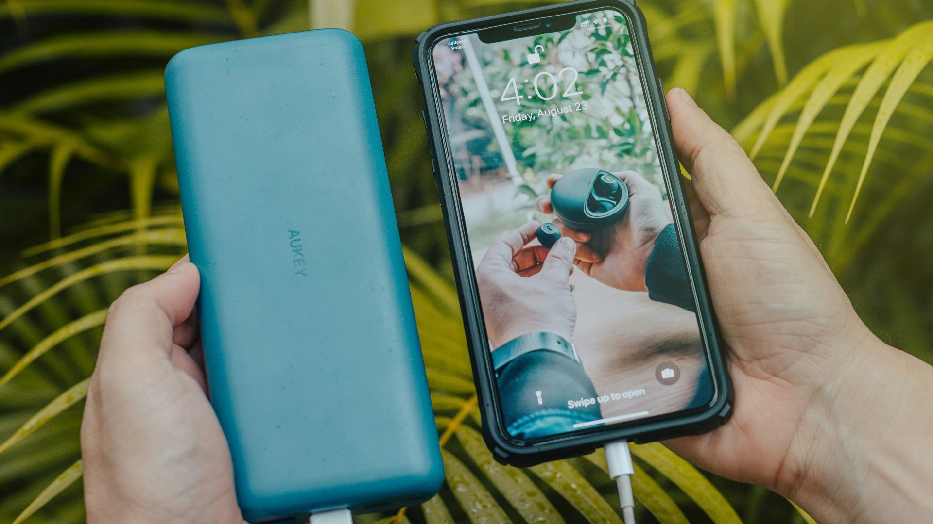 black smartphone and green powerbank close-up photography