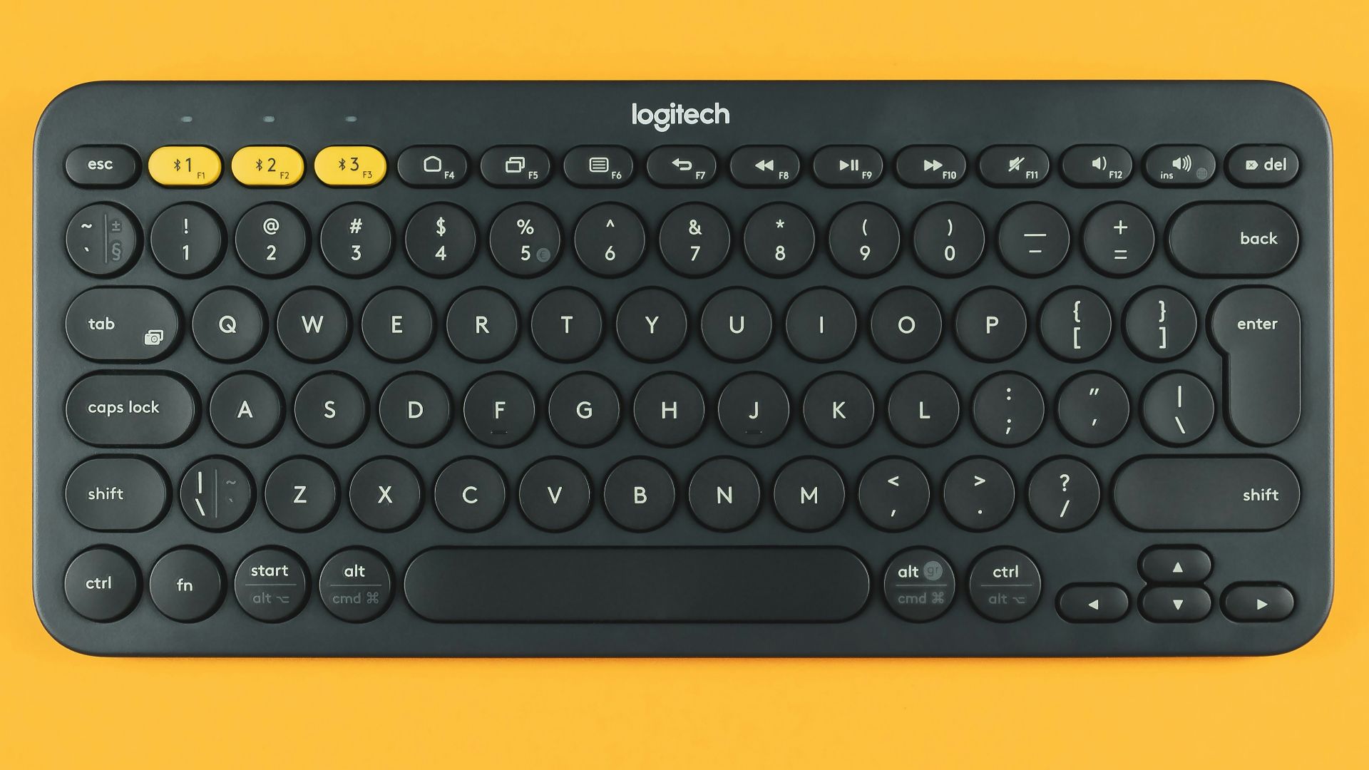 black logitech keyboard on orange surface