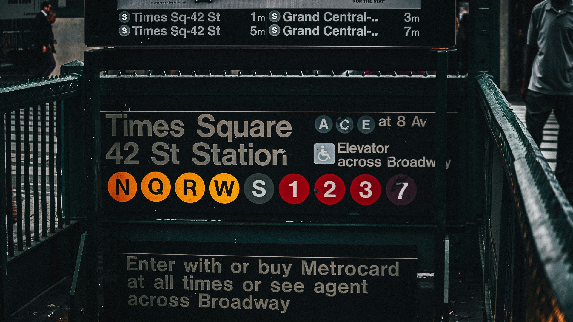 a bus stop with a sign that says times square and 42 st station