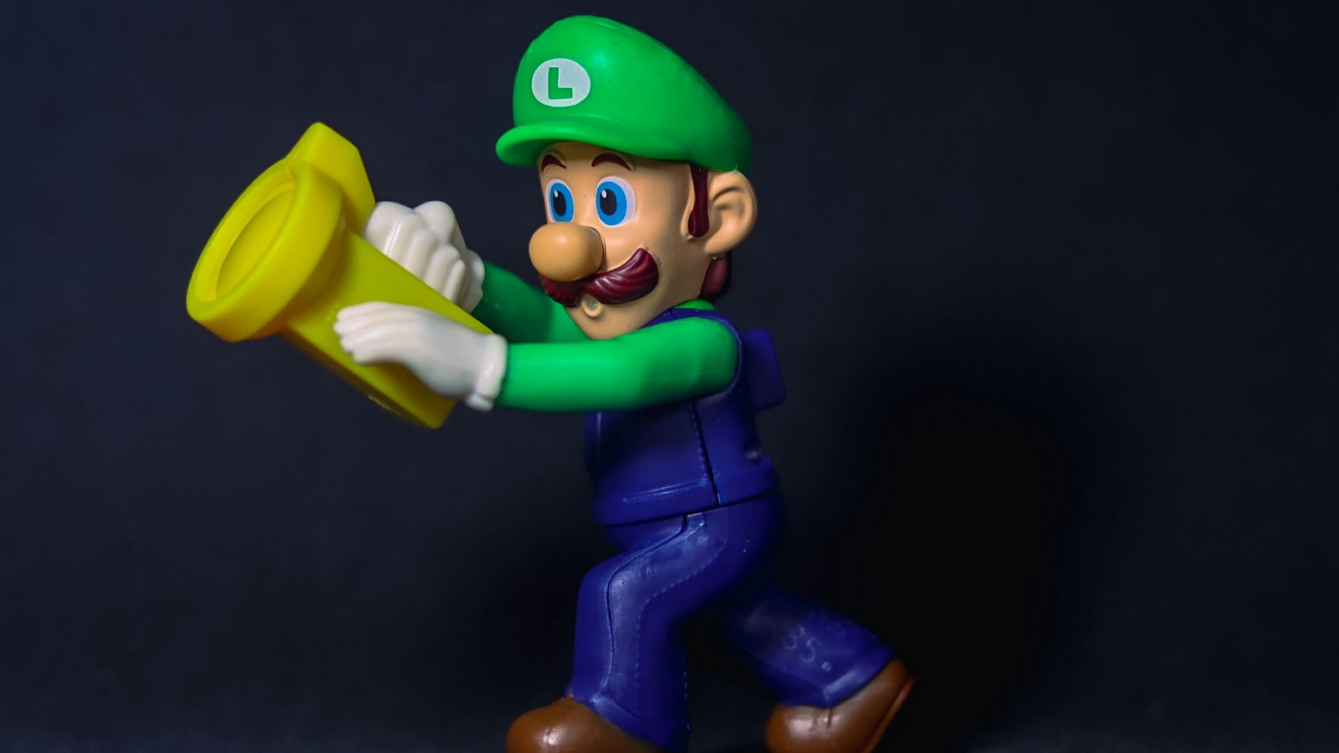 a figurine of a man holding a yellow frisbee