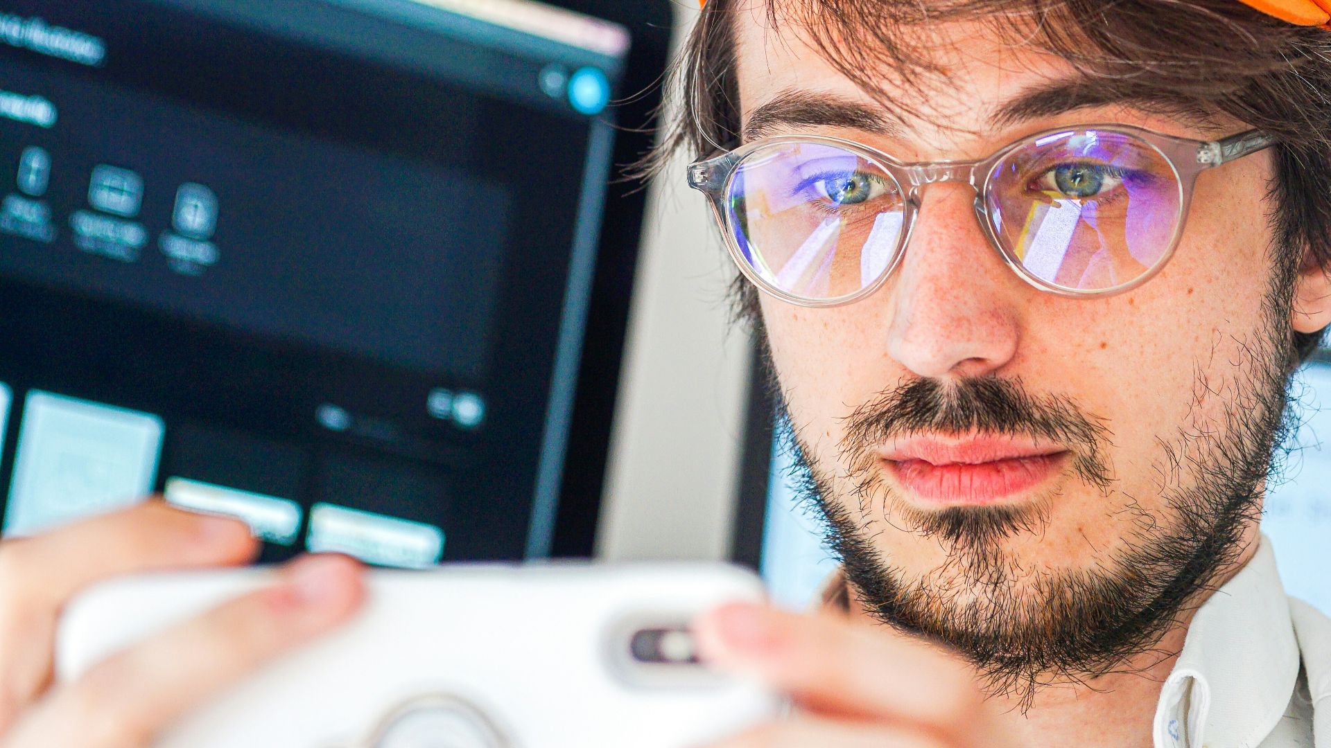 man in orange cap and black framed eyeglasses