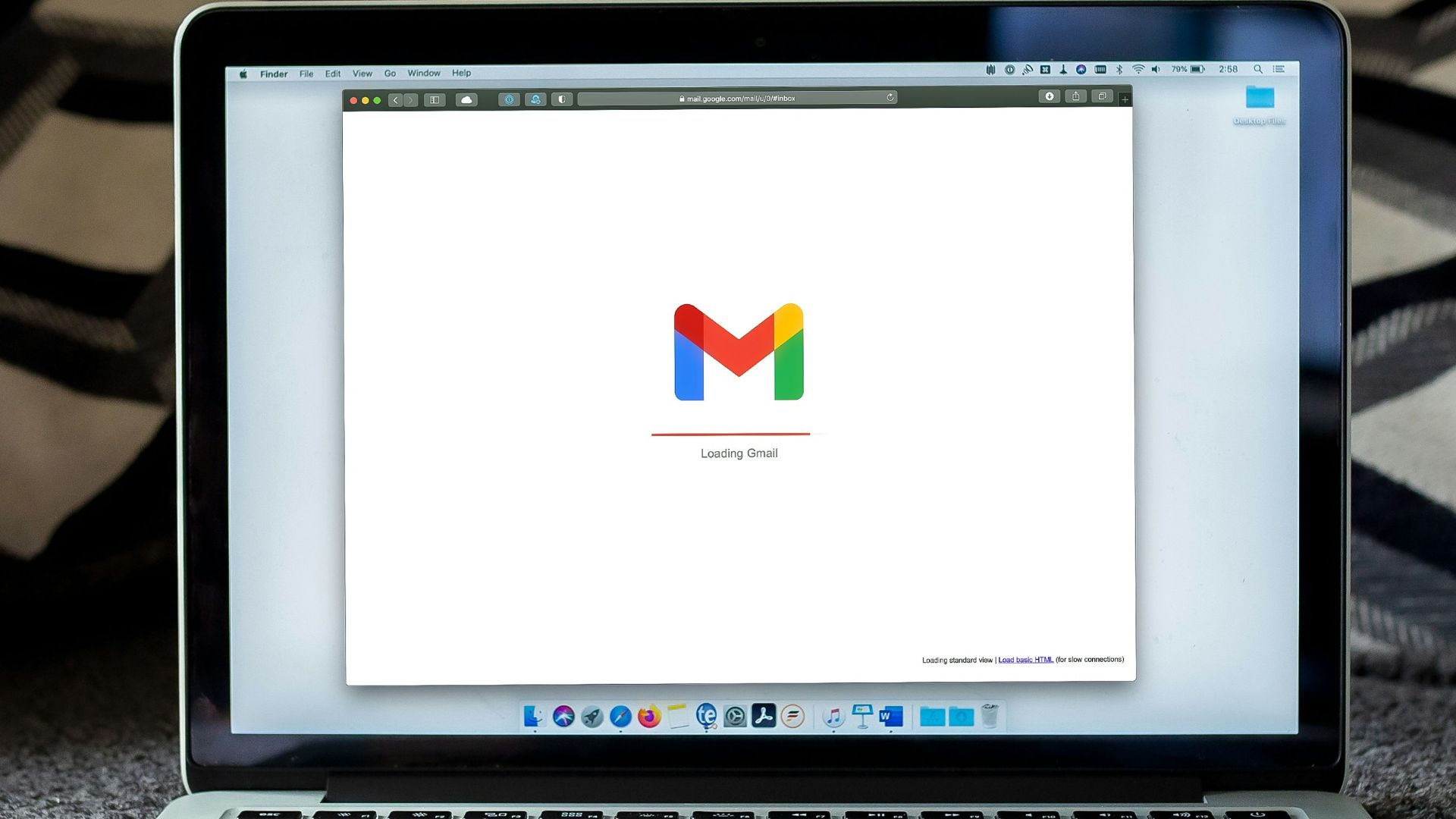 macbook pro on black textile