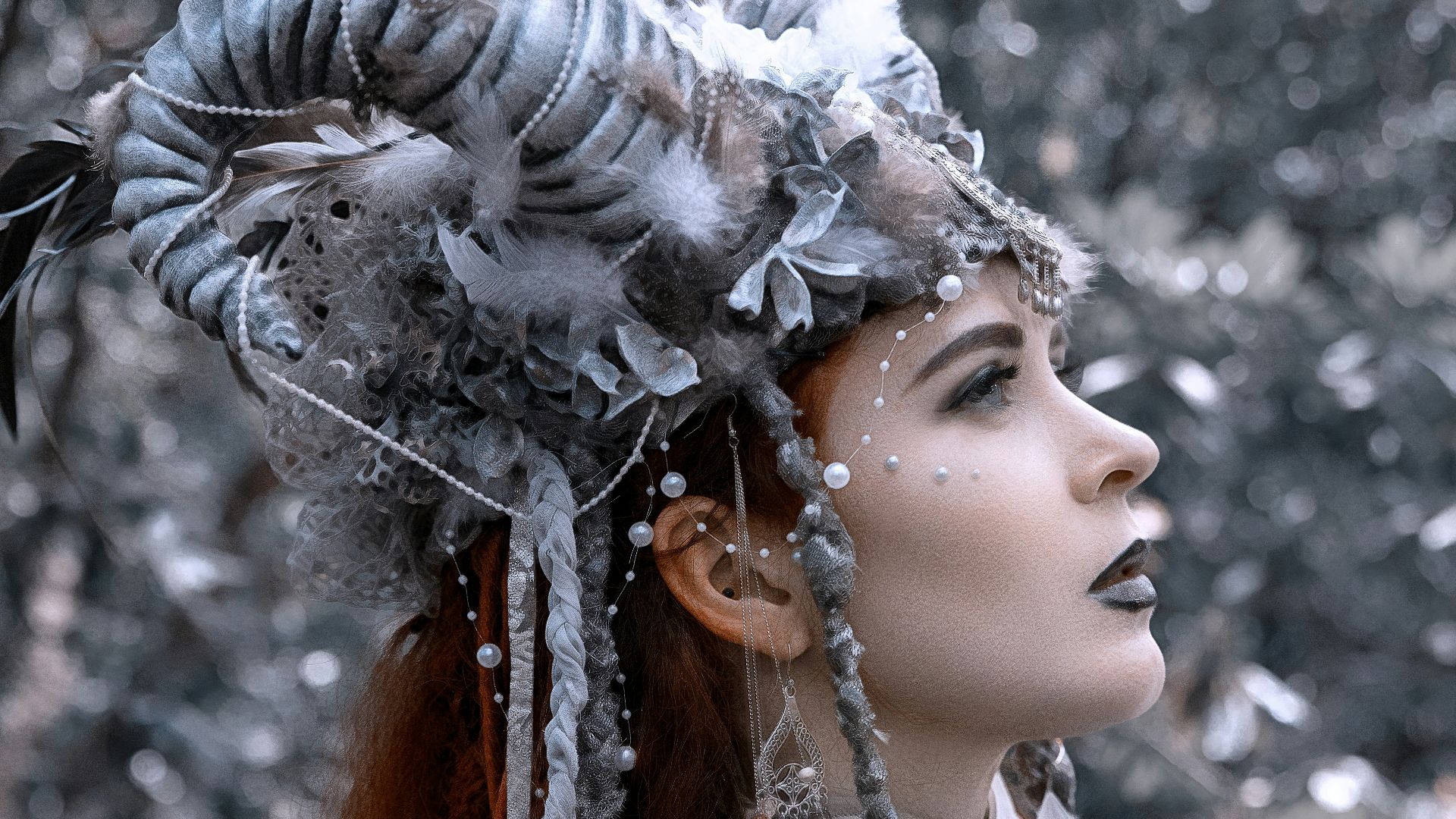 a woman in a costume with feathers on her head