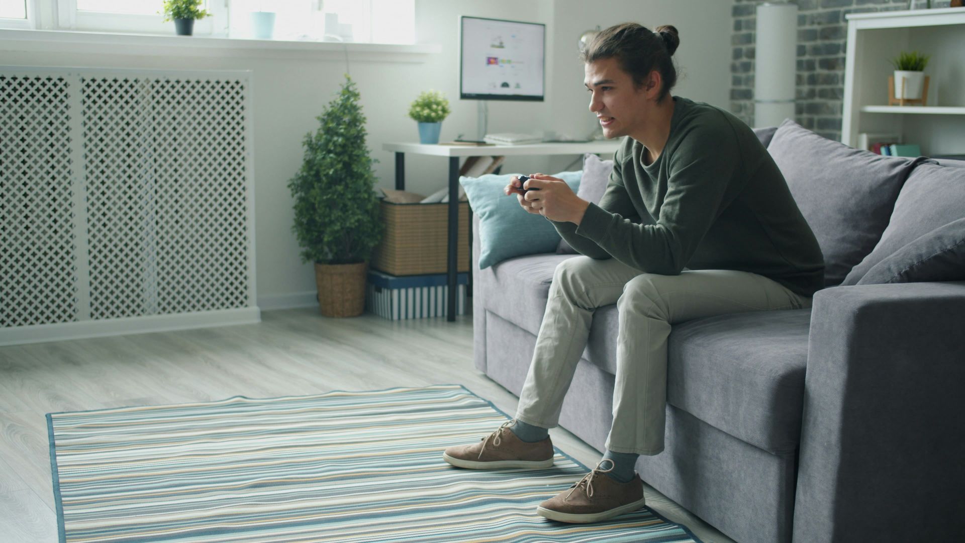 Man playing video games on couch