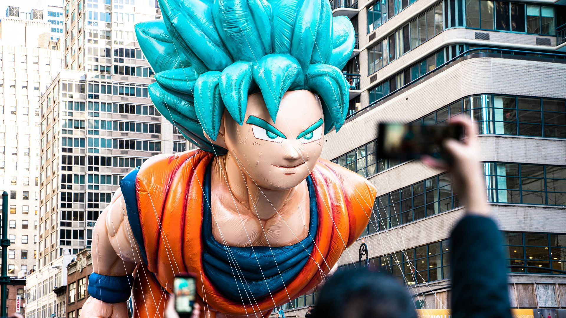 a large balloon of a dragon is being held up in the air