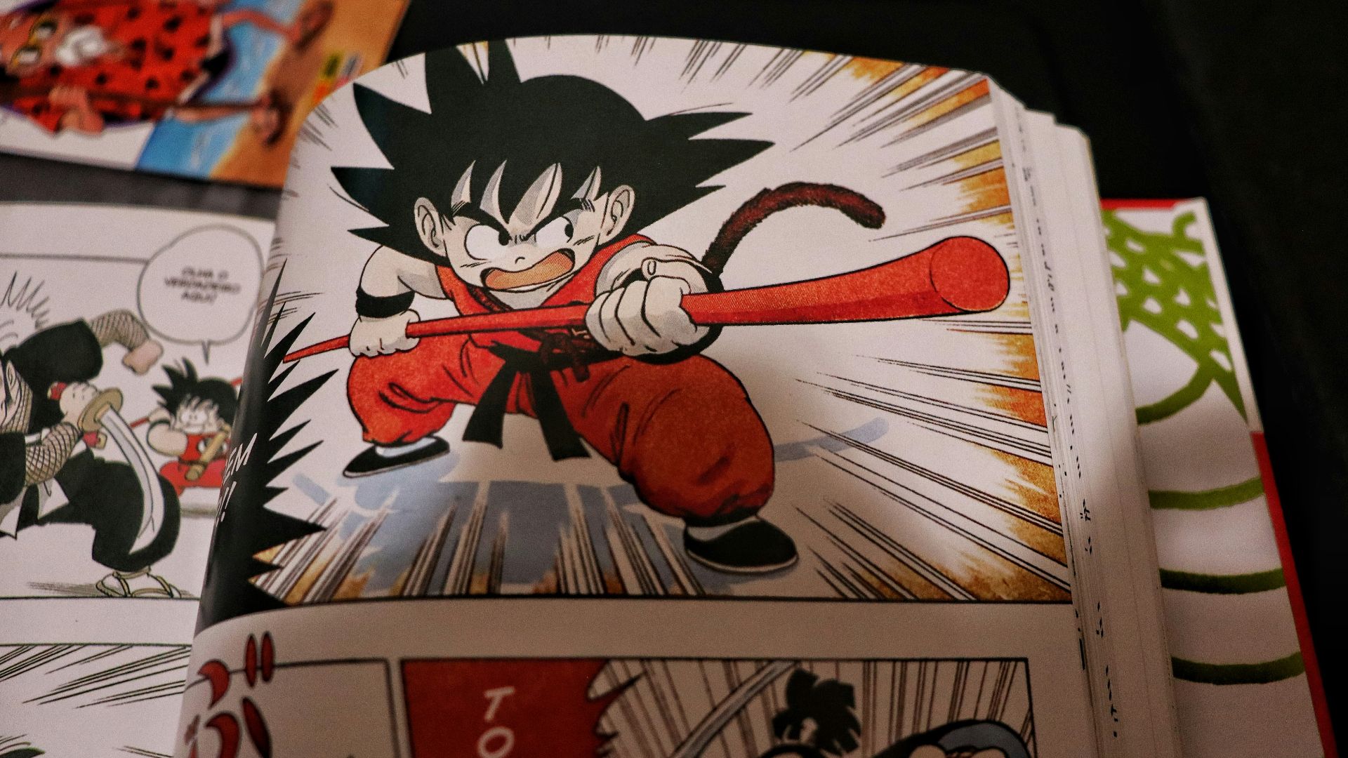 Young goku in action with a red staff.
