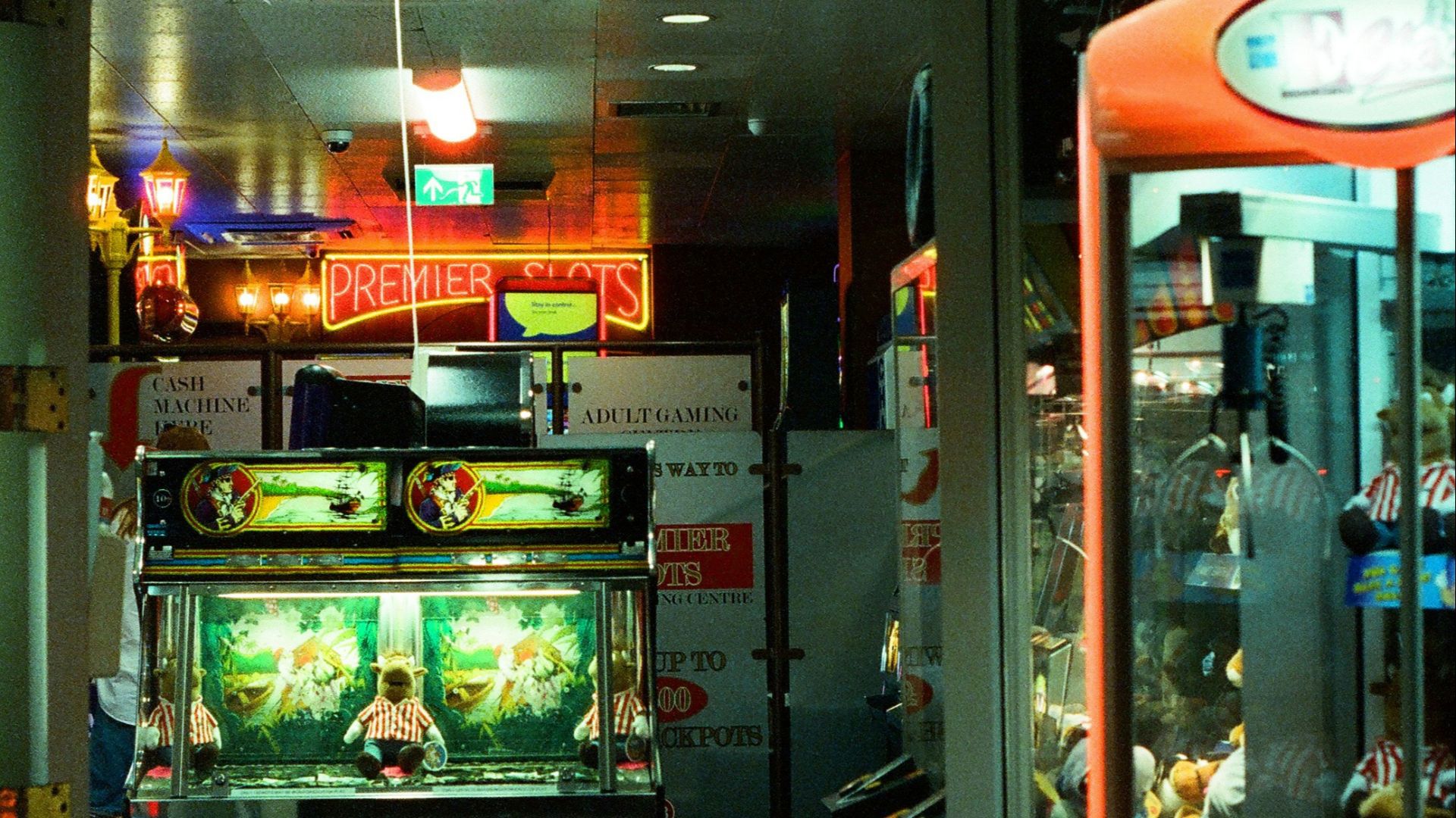 Amusements arcade entrance with neon signs and games.