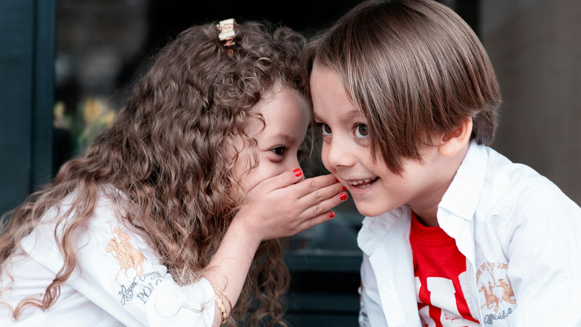 woman in white long sleeve shirt kissing girl in white long sleeve shirt