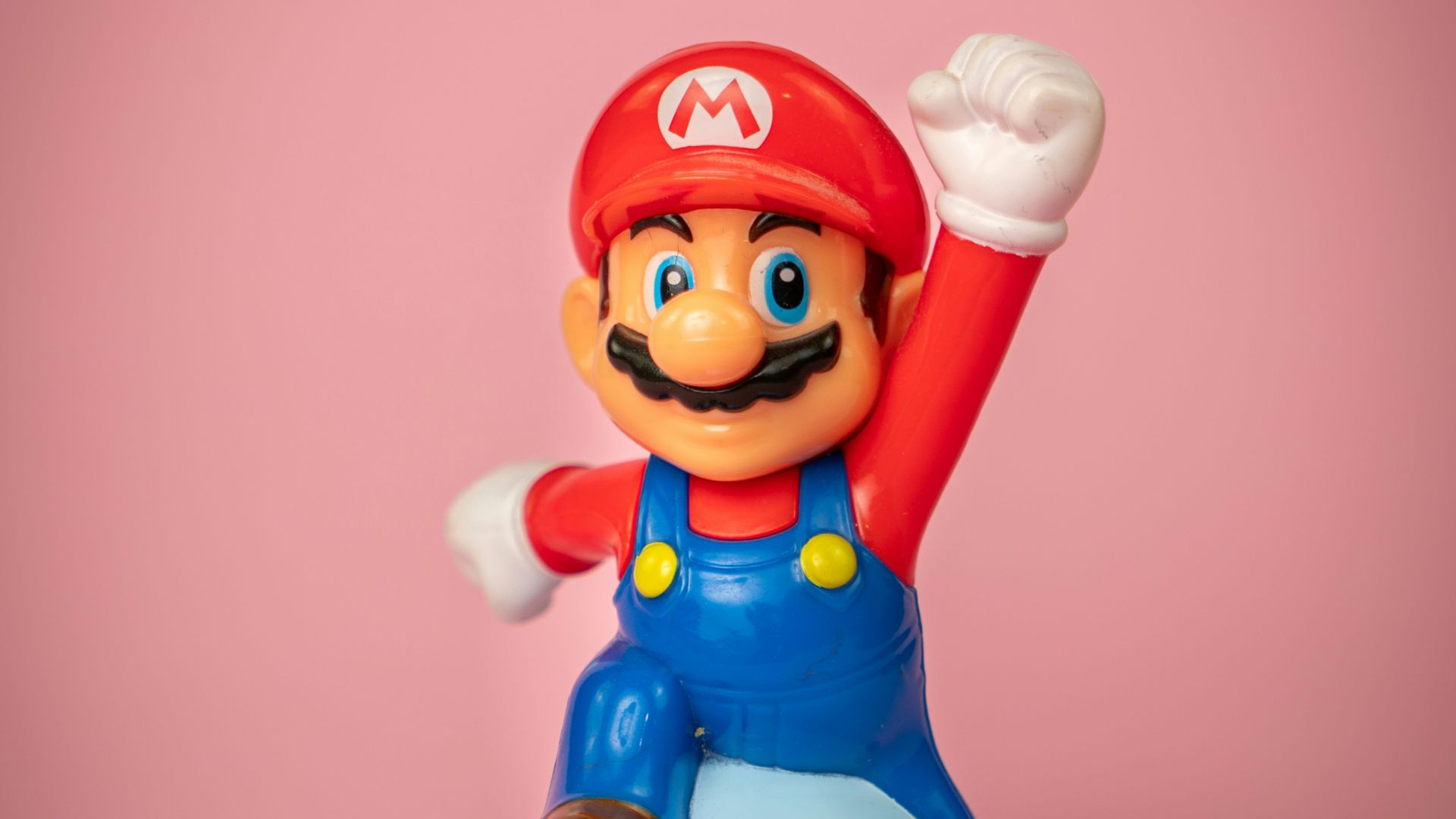 a toy figure of mario on top of a blue object