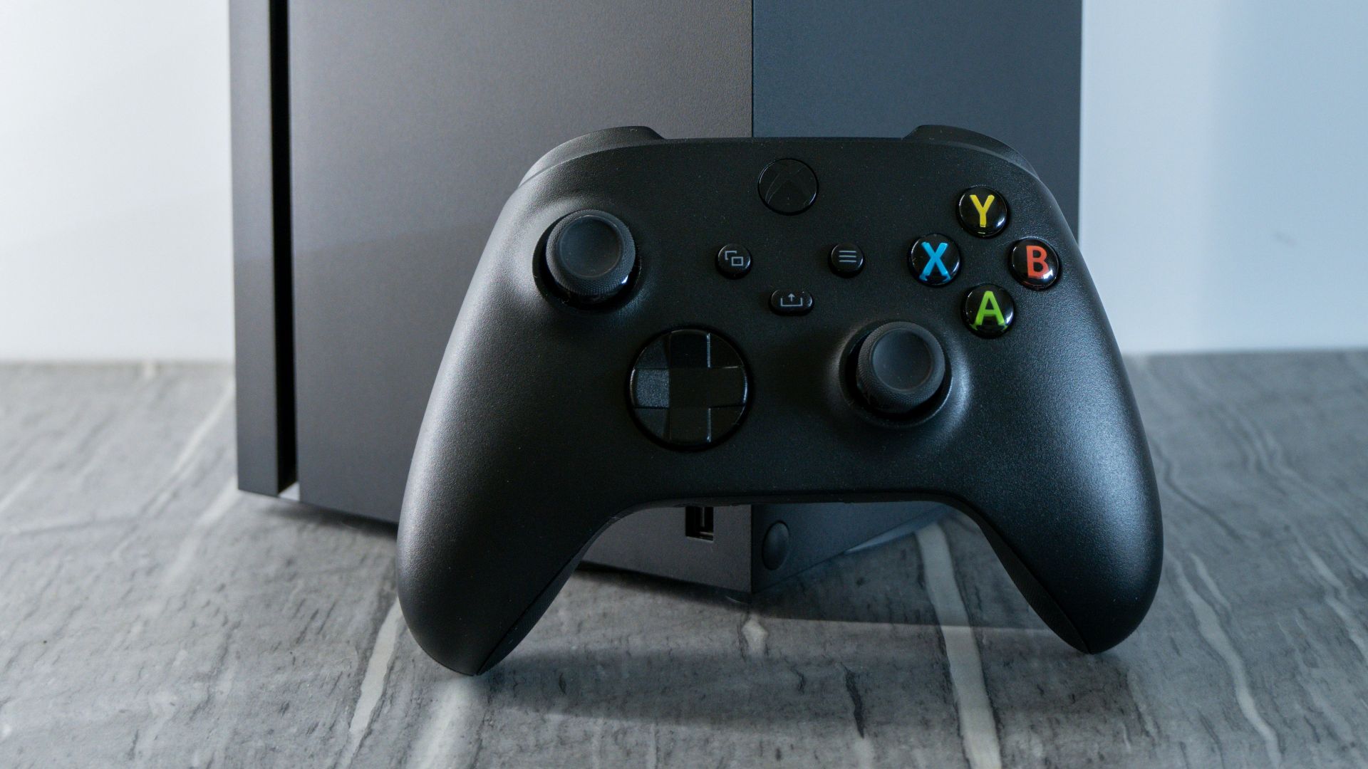 a video game controller sitting next to a box