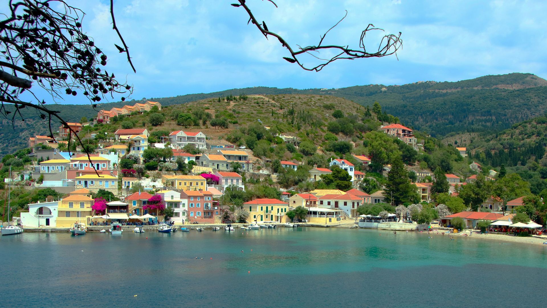 a small village on a hill above a body of water