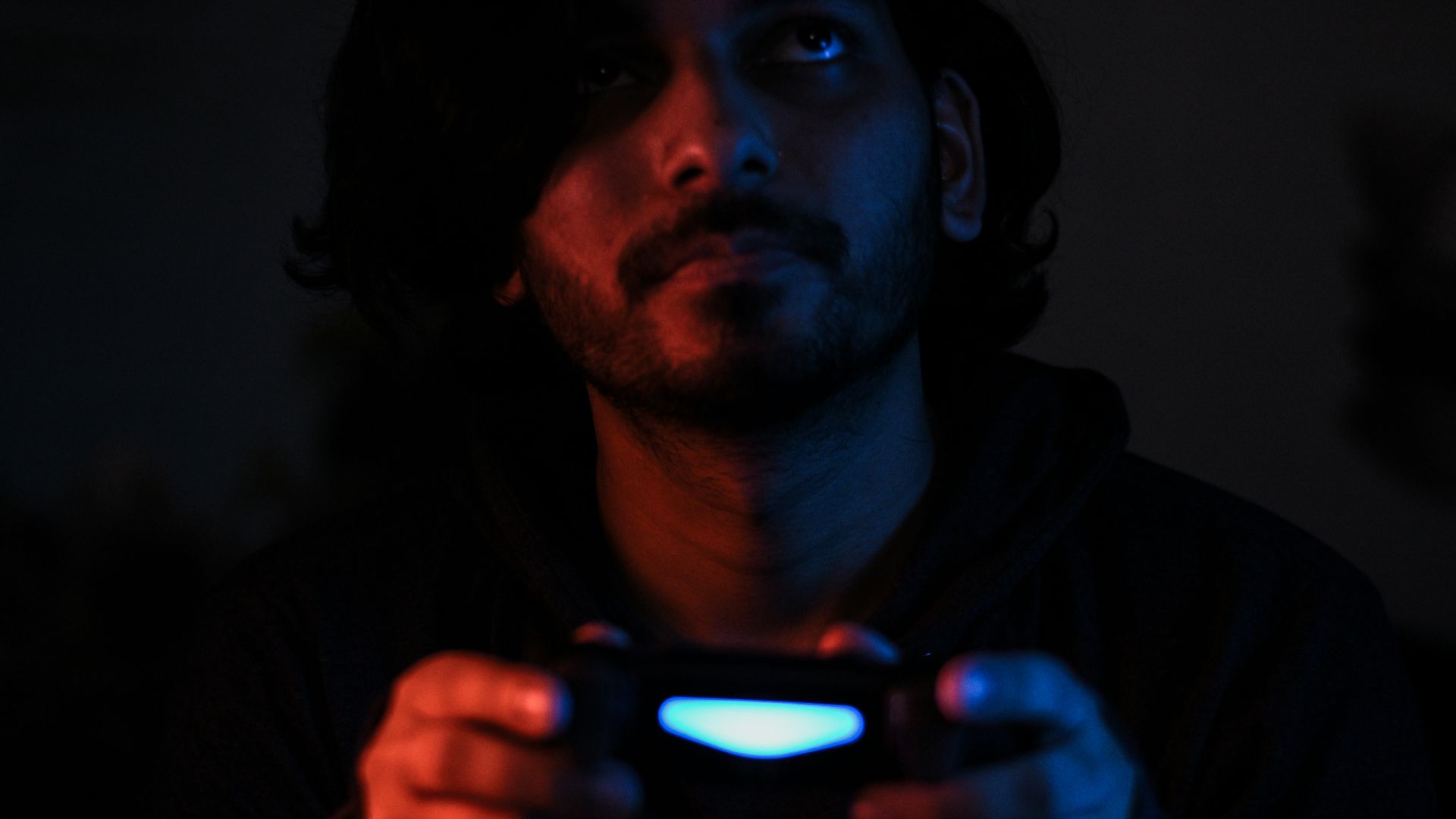 man in black jacket holding black smartphone