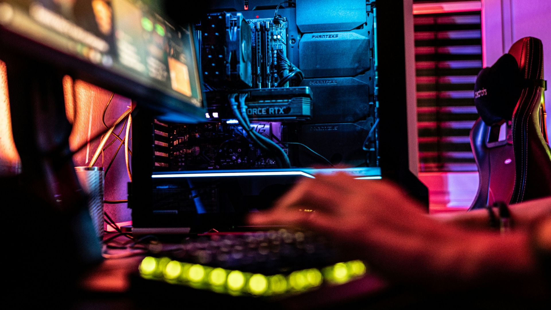 a person sitting in front of a computer monitor